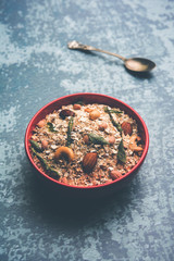 Oats Chivda / Chiwda is a healthy indian recipe with added chilli, peanuts, cashew, almond and curry leaf for flavour. Selective focus