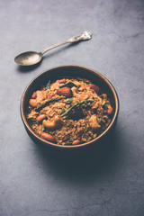 Oats Chivda / Chiwda is a healthy indian recipe with added chilli, peanuts, cashew, almond and curry leaf for flavour. Selective focus