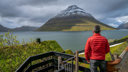 Unidentified man overlooking the scenery of Faroe Islands, Denmark