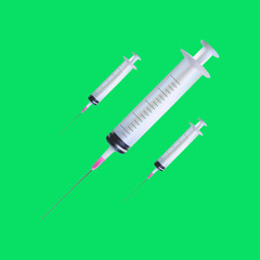 simple medical syringes are isolated against a green background