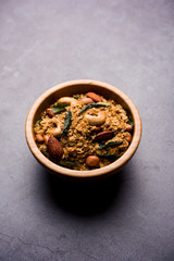Oats Chivda / Chiwda is a healthy indian recipe with added chilli, peanuts, cashew, almond and curry leaf for flavour. Selective focus