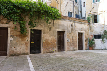 Fototapeta na wymiar Row of front doors in Venice, Italy