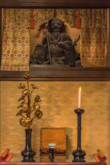 Wooden statue of Shinto deity Juronin which is represented with a deer, a candle and a golden lotus flower at Zen Choanji temple in Tokyo.