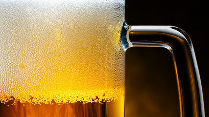 Light Beer Mug with White Foam on Dark Background Close Up