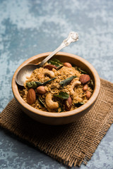 Oats Chivda / Chiwda is a healthy indian recipe with added chilli, peanuts, cashew, almond and curry leaf for flavour. Selective focus