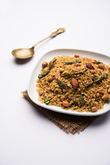 Oats Chivda / Chiwda is a healthy indian recipe with added chilli, peanuts, cashew, almond and curry leaf for flavour. Selective focus