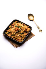 Oats Chivda / Chiwda is a healthy indian recipe with added chilli, peanuts, cashew, almond and curry leaf for flavour. Selective focus