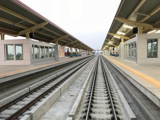 Train station with empty train tracks for the train from the perspective of from on the train that runs out of the public transport station illustration