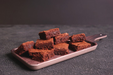    Dark chocolate dessert - homemade brownie cake on cosy plate  on dark textured background....