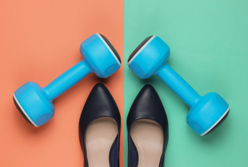 Leddy's sport. Women's high heel shoes with dumbbells on pastel background. Fitness and fashion concept. Top view, minimalism