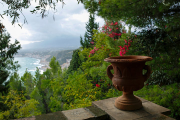 clay vase with view in the background of Giardini Naxos seen from Taormina, Sicily, Italy