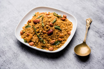 Oats Chivda / Chiwda is a healthy indian recipe with added chilli, peanuts, cashew, almond and curry leaf for flavour. Selective focus