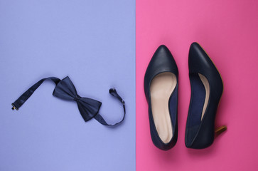 Minimalistic fashion still life. Women's high heel shoes and bow tie on pink purple background. Top view - Powered by Adobe