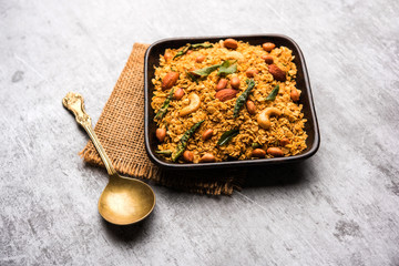 Oats Chivda / Chiwda is a healthy indian recipe with added chilli, peanuts, cashew, almond and curry leaf for flavour. Selective focus