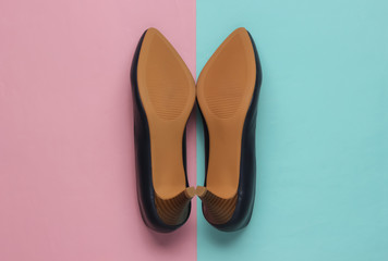 the sole of leather women's shoes with heels on blue-pink pastel background. Minimalistic fashion. Top view