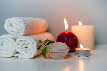 Obraz na płótnie Canvas Massage & SPA procedures photo with fresh towels, sea salt for bath and aroma candles, horizontal orientation.