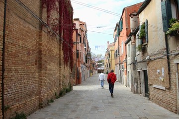 Residential street in Venice, Castello district.  Clothing lines between the buildings  Italy, Europe.