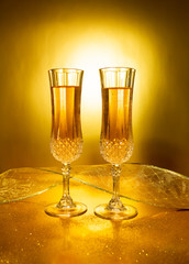 Two glasses of Champagne on Golden background