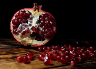 ripe pomegranate on a dark background © Наталья Максакова