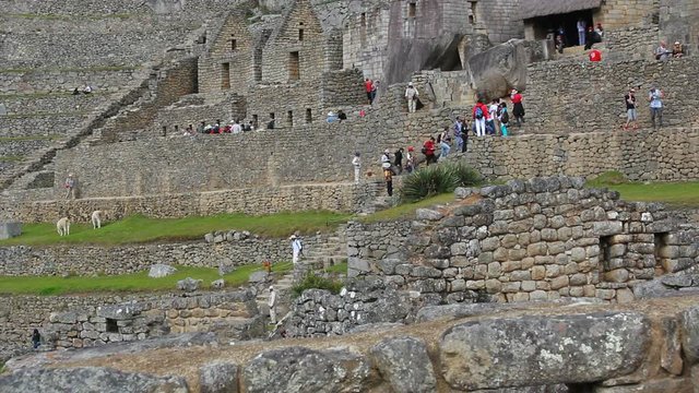 Tourists visiting Machu Picchu, Peru - UNESCO World Heritage Site 