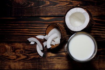 top view sliced ​​on a wooden table coconut, a glass of milk