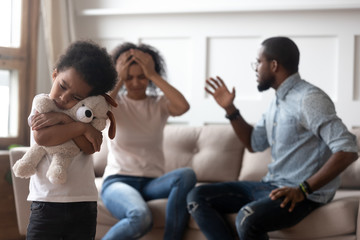 African boy feels lonely embraces toy suffers from parents scandal