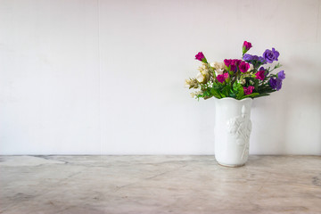 Isolate  art white basket and colorful flowers place on grey marble surface table and white and clear Concrete wall. Abstract background  and nobody template with relaxation feeiling clean and clear.