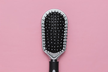 Comb on pink pastel background. Beauty minimalistic concept. Hair care. Top view