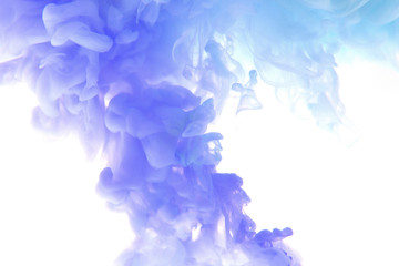 Abstract flowing liquid or blue ink in water on a white background. It looks like smoke or cloud....