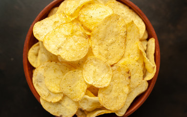 potato chips in a bowl, beer snacks on a stone background