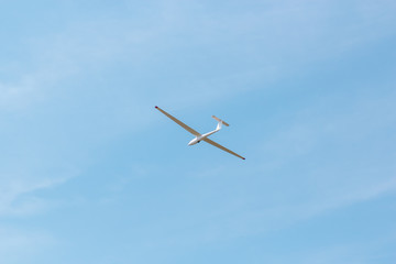 Small glider flying against the pink sky, concept of dream, happy future and positive outlook on life