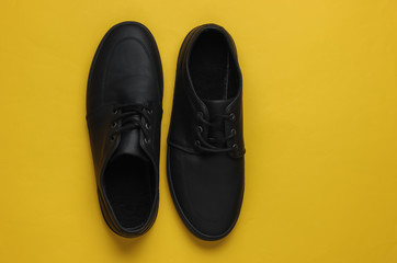 Men's leather black shoes on paper background. Top view