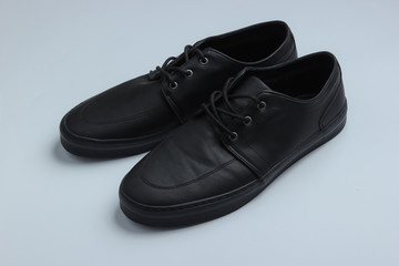 Men's leather black shoes on a white background.