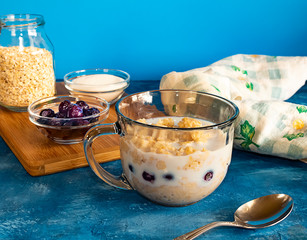 Oatmeal with Blueberries and Milk on blue background