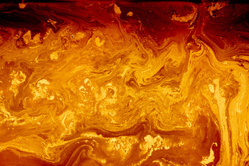 Abstract golden orange background. Flashes in the sun, liquid fire. Flowing lava colors paint