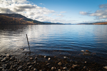 An autumnal image of the clam waters of Loch Rannoch in afternoon sunlight, Perth and Kinross, Scotland. 
