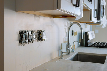 Work on installing electrical outlets for kitchen
