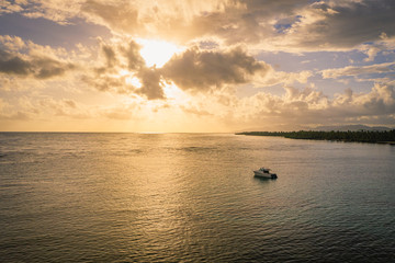 Luxury boat anchored close to exotic tropical beach..Aerial view at sunset of Samana peninsula in Dominican republic.