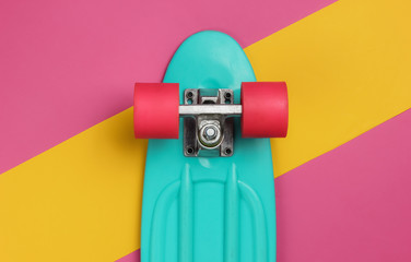 Cruiser board on colored paper background. Summer fun. Studio shot. Top view