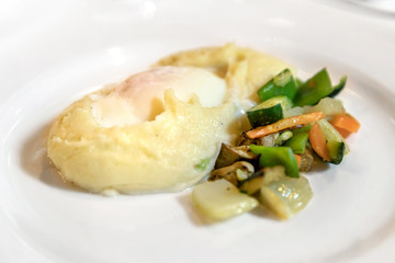 Plate of mashed potato with egg