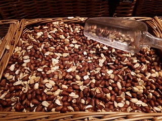  close-up of tasty, healthy, organic peanuts peeled in a wicker basket