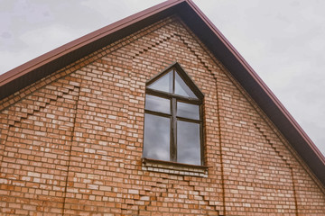 Beautiful pink brick brick house and orange roof. Corrugated met