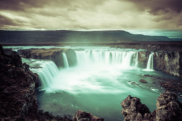 Fototapeta premium Godafoss waterfall, foggy from waterspray on a cloudy morning, Iceland