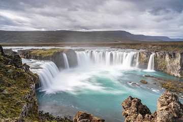 Fototapeta premium Godafoss waterfall, foggy from waterspray on a cloudy morning, Iceland