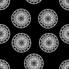 Black and white seamless pattern of mandalas.