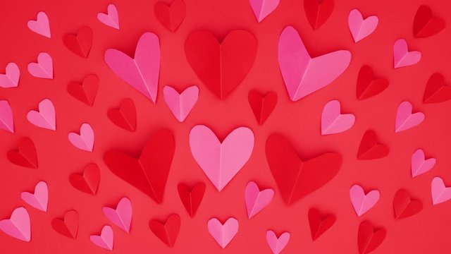 Red and pink hearts appear on red background - Stop motion Valentine's day 