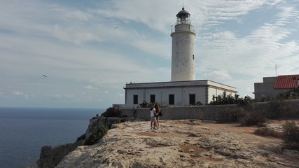 Fototapeta premium the beautiful lighthouse on the cliff overlooking the island of Formentera in the Balearic Islands