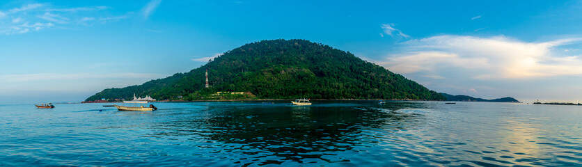 Naklejka na ściany i meble Besar, Perhentian Island, Malaysia; 18-May-2019; a panoramic view of Perhentian Kecil from Perhentian Besur at sunset, Perhentian Islands, Malaysia