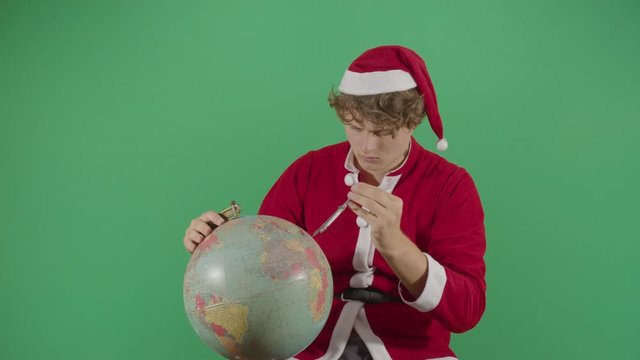 Adult Man Santa Claus Mesuring The Globe
