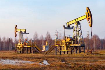 Oil pump jack rocking with pipeline in the background. Rocking machines for power generation....